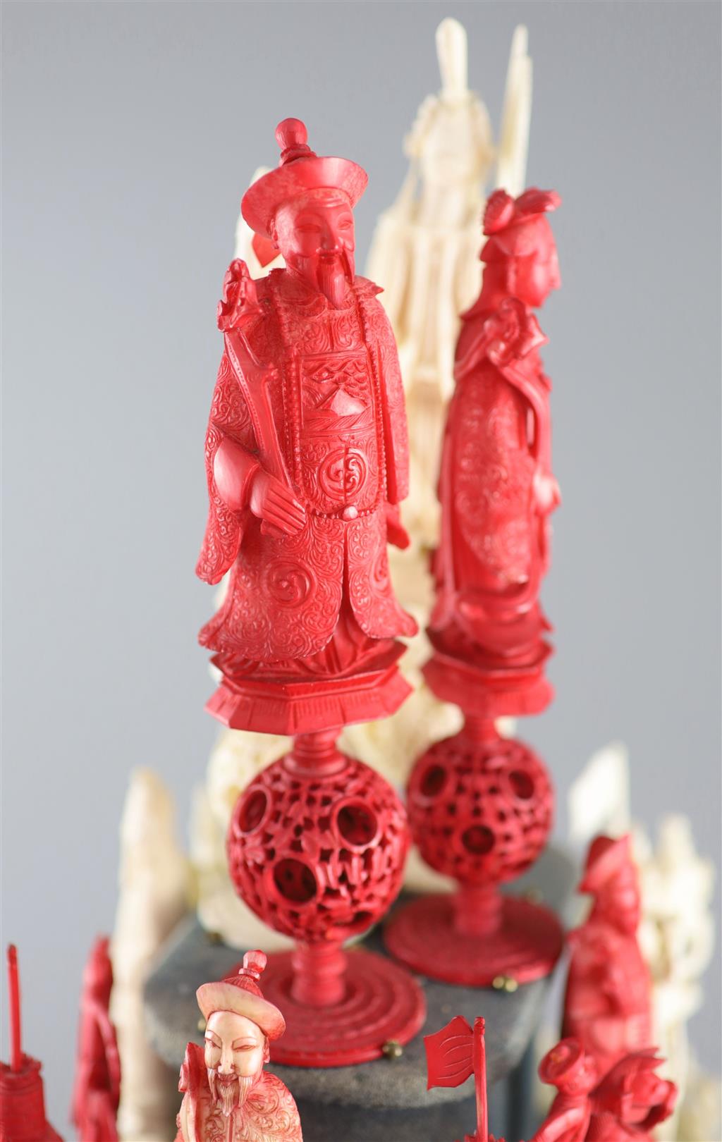 A set of 19th century Cantonese carved and red stained ivory chess pieces under dome, white king 20cm high